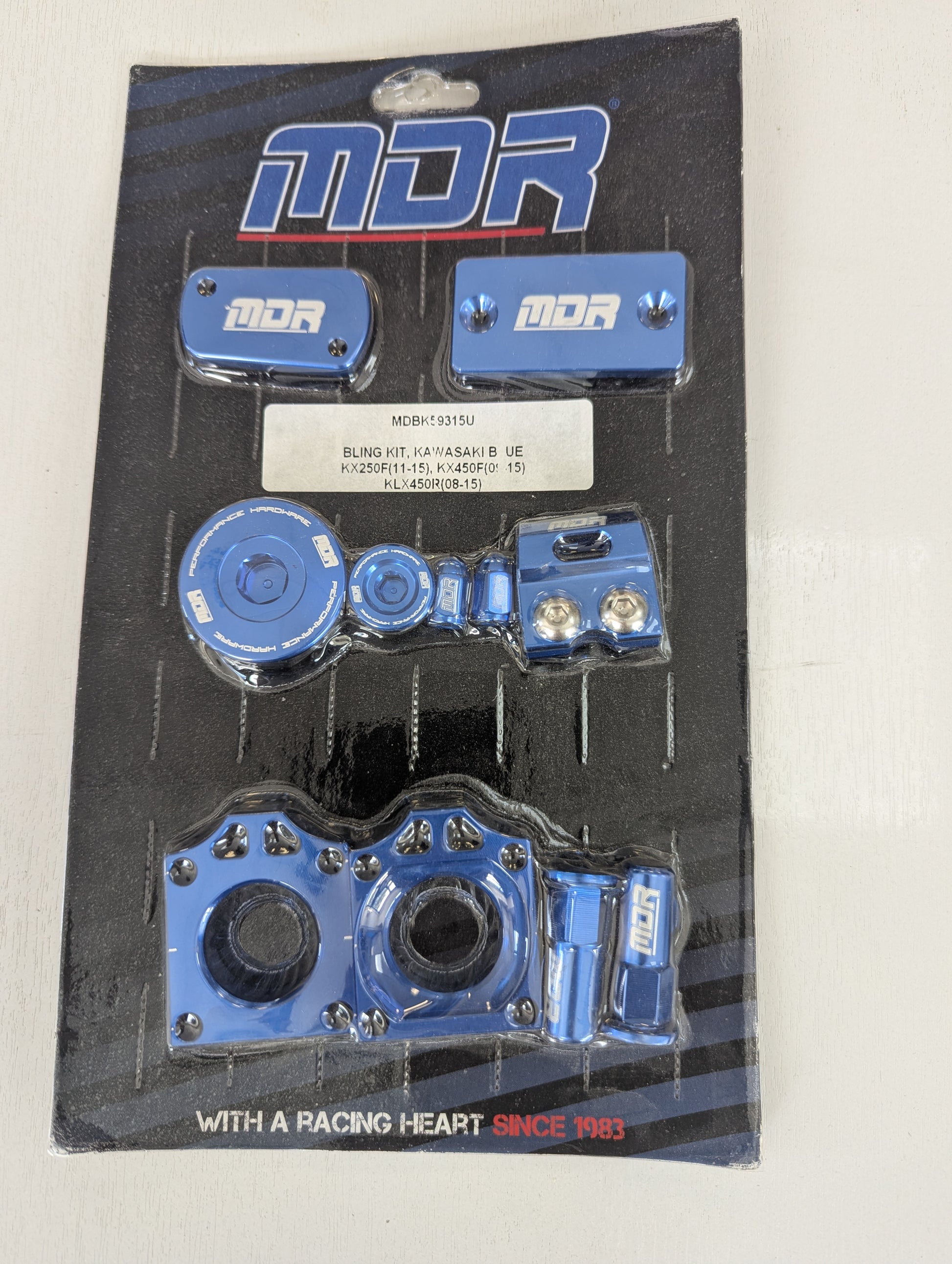 MDR blue racing handlebar clamps and mounting hardware in original blister packaging.